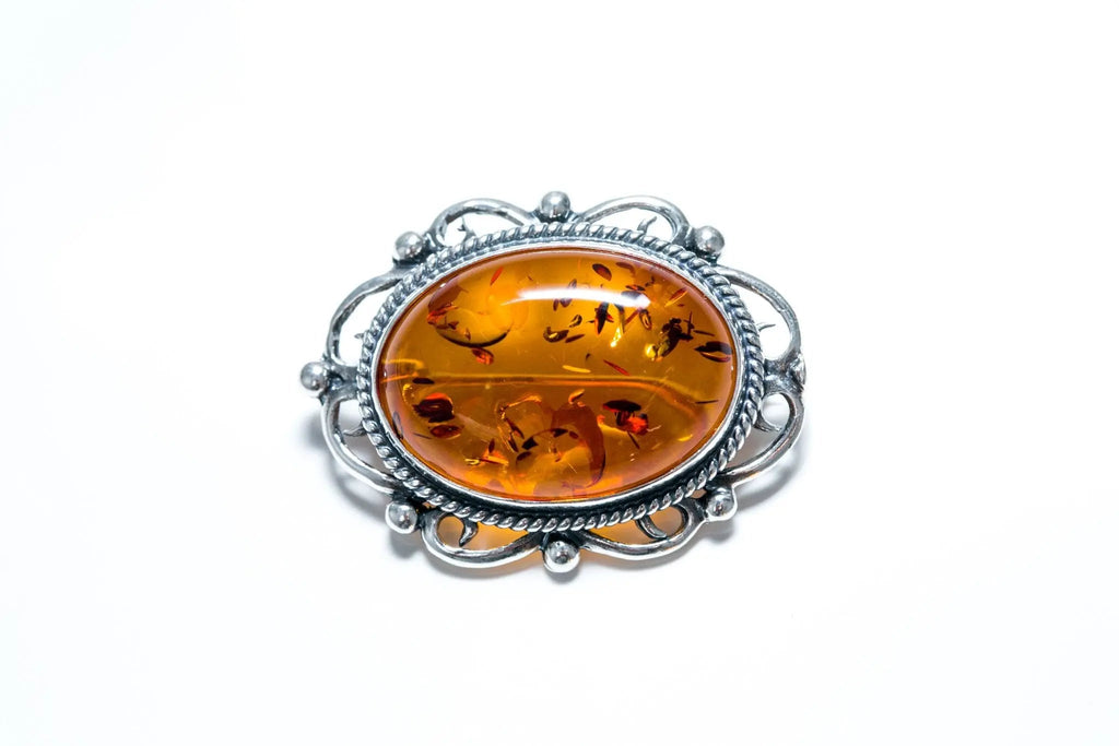 Broche ovale classique en ambre encadré