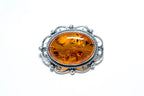 Broche ovale classique en ambre encadré