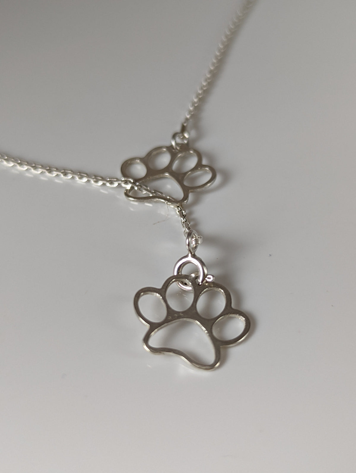 Silver Steed Thread Through Double Paw Print Silver Necklace