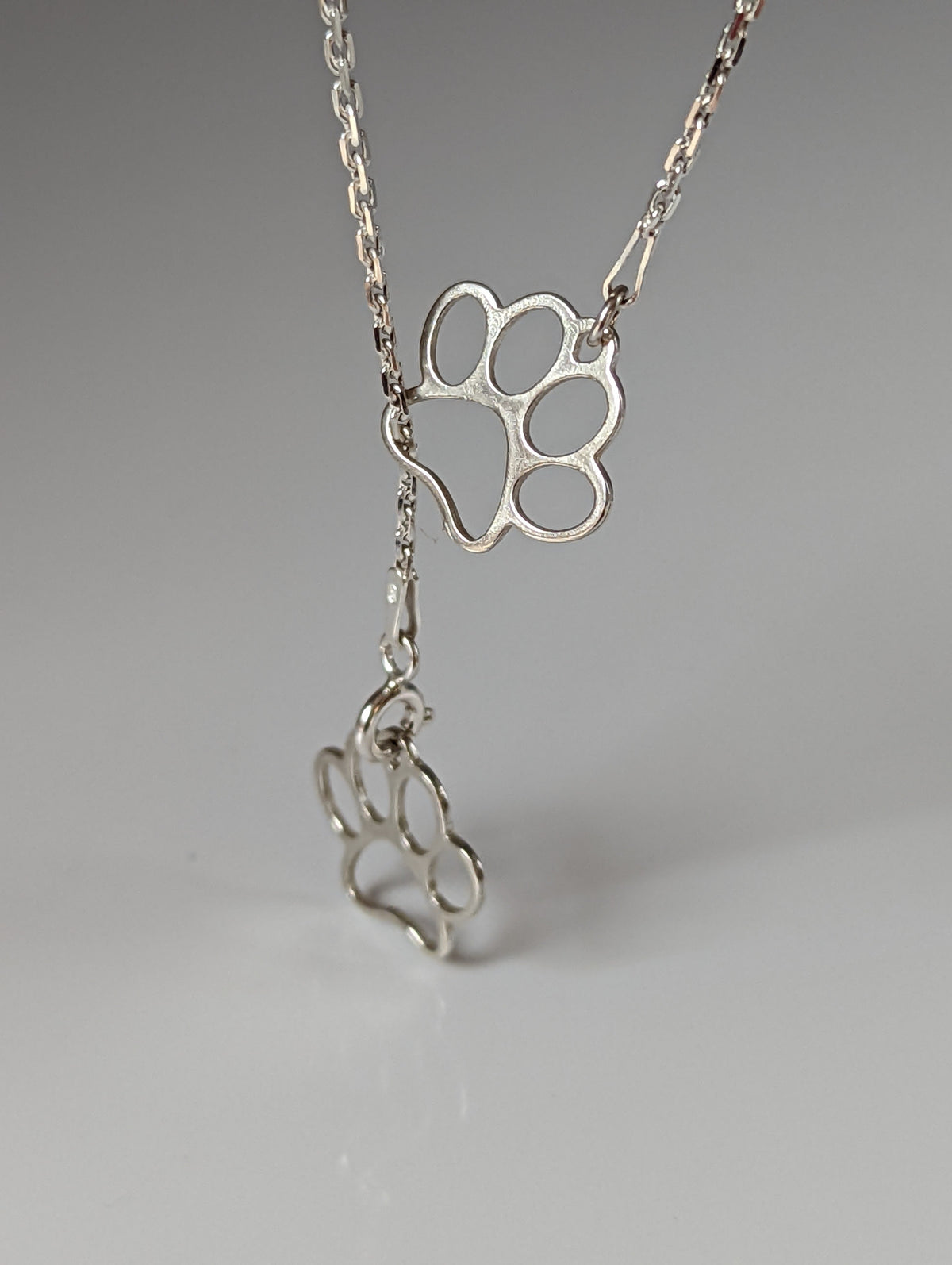 Silver Steed Thread Through Double Paw Print Silver Necklace